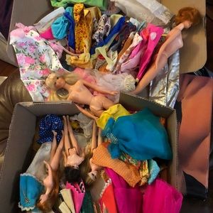 Many vintage Barbies with box of clothes